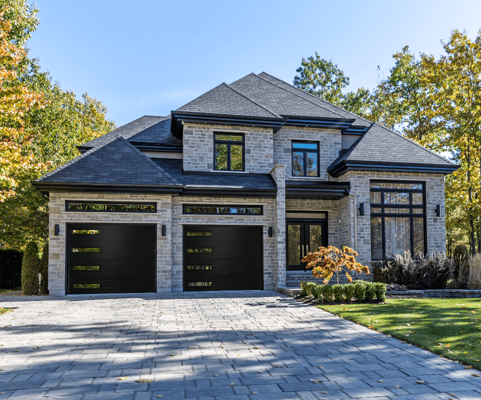 luxury house with black garage doors